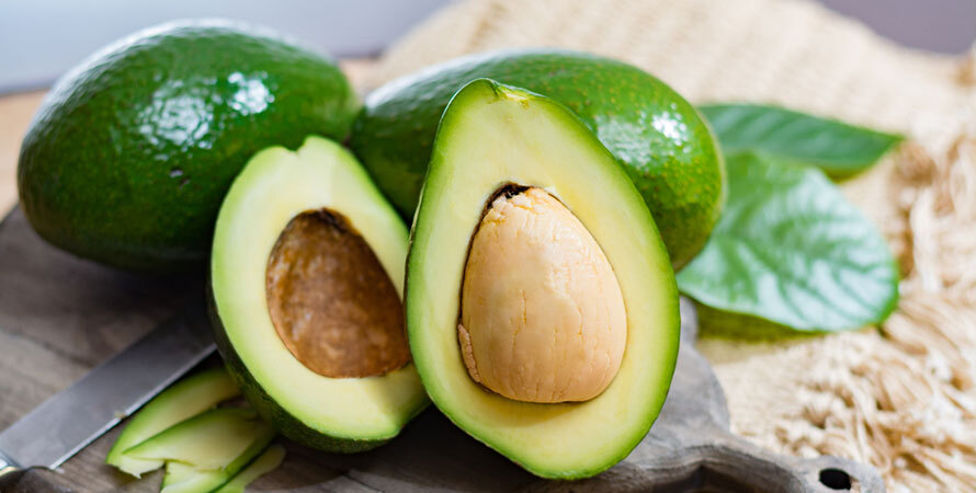 halved avocado with seed visible showing how avocado pit can be used for joint pain relief