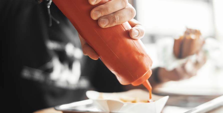 man pours ketchup